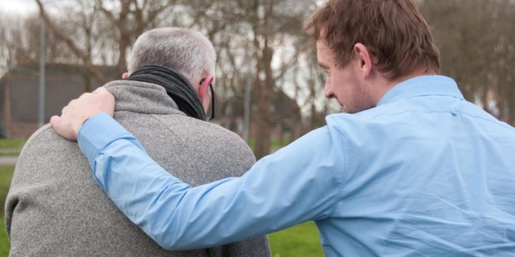 Friends of Hope - man with hand on shoulder of elderly man
